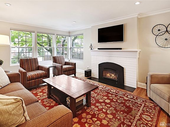 The living room has beautiful wood floors, new gas fireplace insert, and large windows looking out to the nicely landscaped front yard. You'll love all the natural light that floods this room on even rainy days.