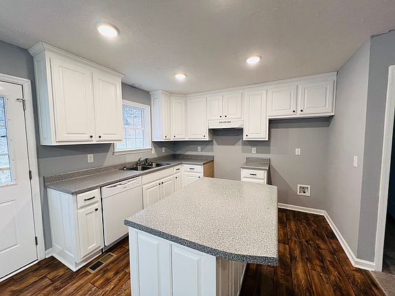 Open kitchen with recessed lighting and an island.