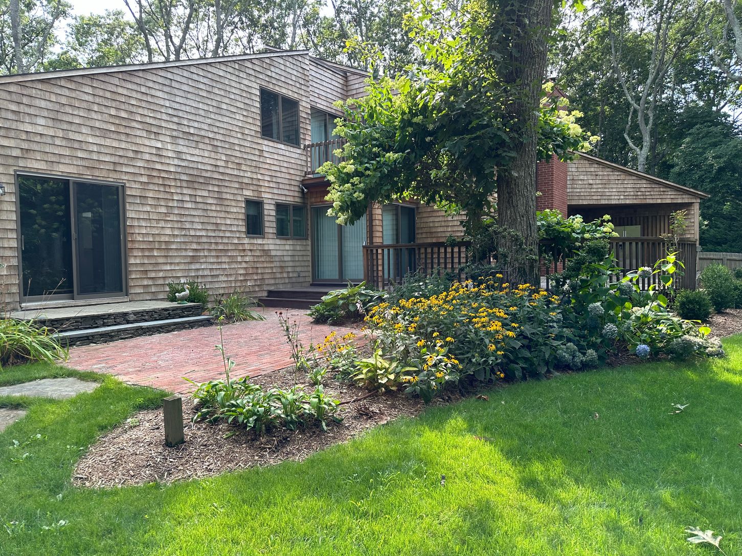 VIEW OF DINING ROOM DOORS AND BRICK PATIO