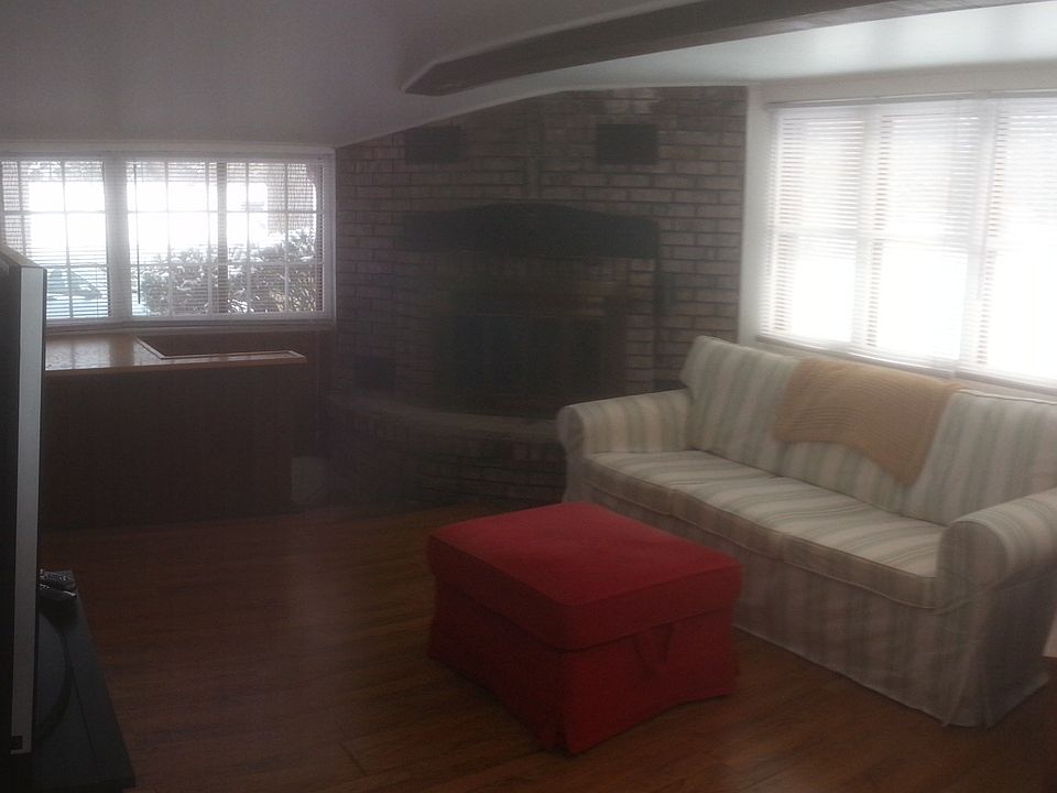 living room w fireplace, lots of windows /french doors. more