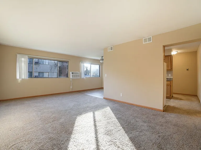 Living room with wall unit air conditioning