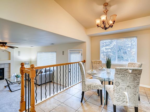 this is the view down to the great room from about the refrigerator - the windows are to the back yard - the door just beyond the railing is to the back yard