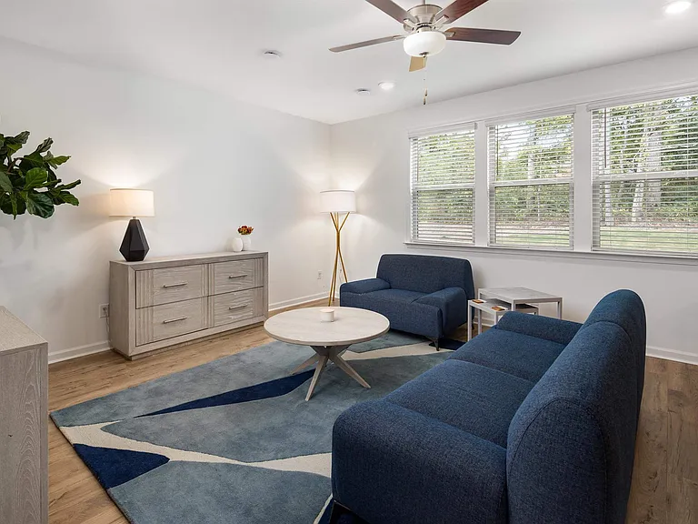 Living room with large windows letting in a ton of natural light.