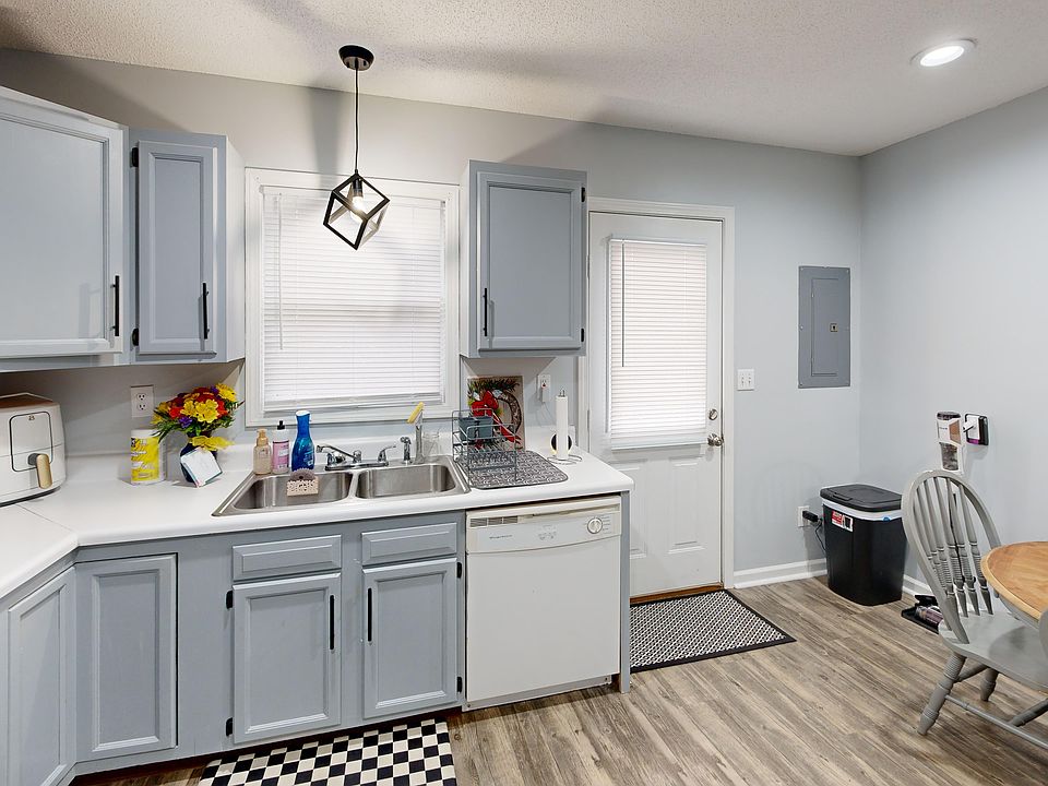 Full-size eat-in kitchen includes refrigerator, stove, and dishwasher. Photo is of a similar unit; available unit has the same floorplan. Fixtures included; furniture and decor not included.