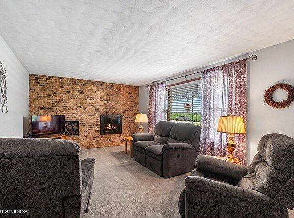 The wood-burning fireplace adds to this room with itâEUR(tm)s own convenient wood storage!