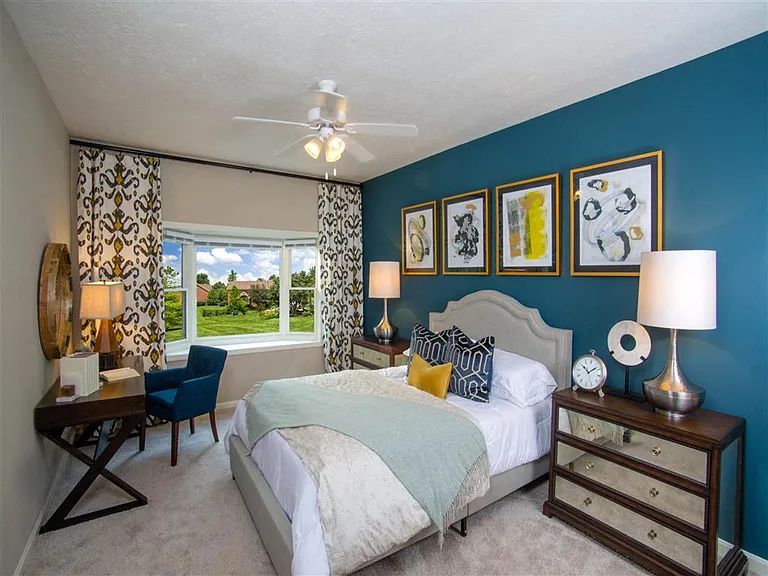 Spacious primary bedroom with bay window