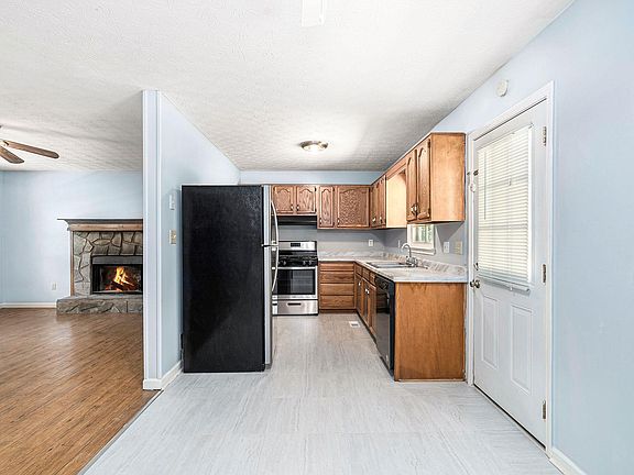 A new fresh kitchen with new appliances and flooring.