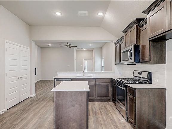 Kitchen in the Amber home plan by Trophy Signature Homes - REPRESENTATIVE PHOTO