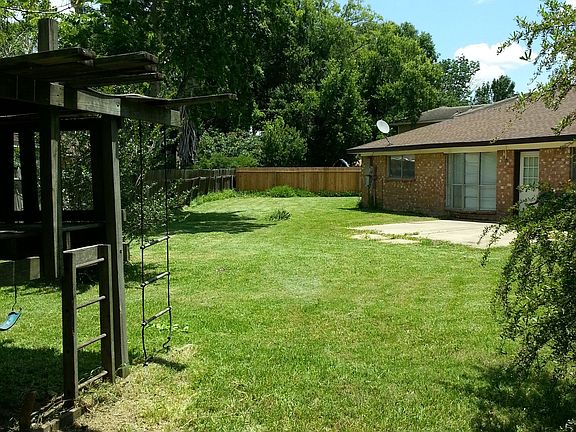Yard with treehouse/fort