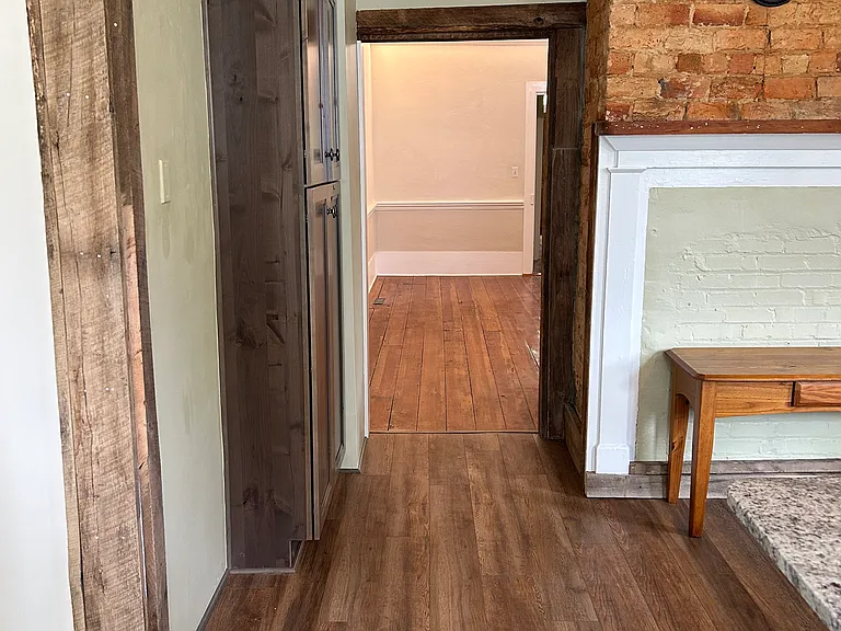 Kitchen looking into entry room with sunroom entry on the left