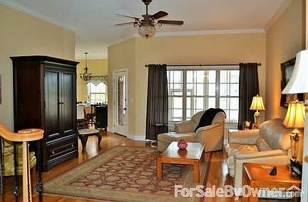 Living Room
						:
						Hardwood floors, remote ceiling fan, crown molding, door to screened in porch