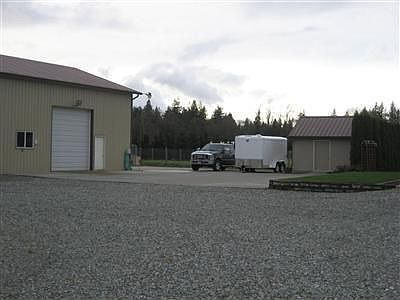 Huge concrete parking area goes all the way behind the shop- makes it easy to expand the shop!
