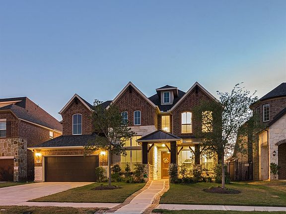 The Attractive Elevation showcases the Stone and Brick exterior beautifully. The address is showcased with a Cast Stone engraved design. The Dual Lamps on either side of the Garage door are a nice touch along with the Walk Way to the home boasting a 