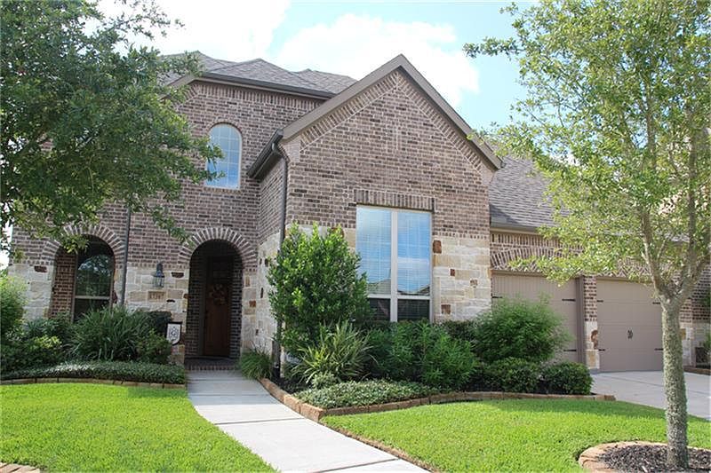 Beautiful stone and brick elevation with uplights.
