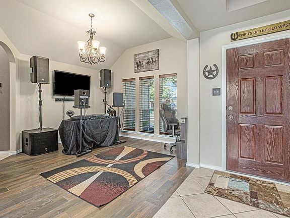 Once inside, you will find a formal dining room with gorgeous wood tile flooring!