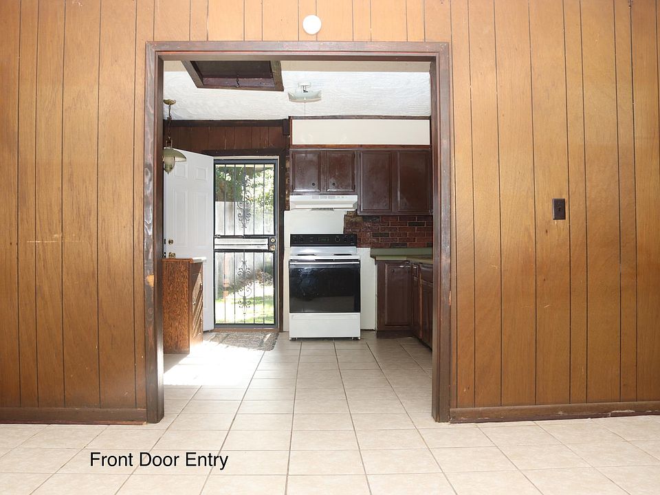 Front door entry view of living room and kitchen