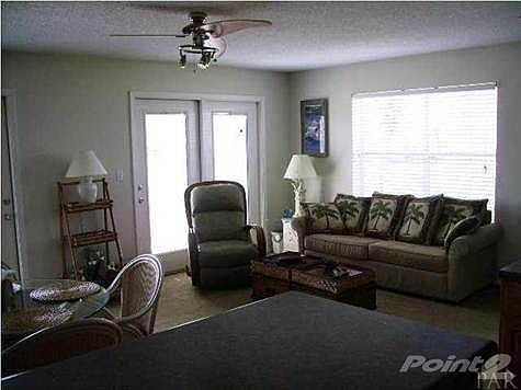 Spacious living area with French doors to balcony