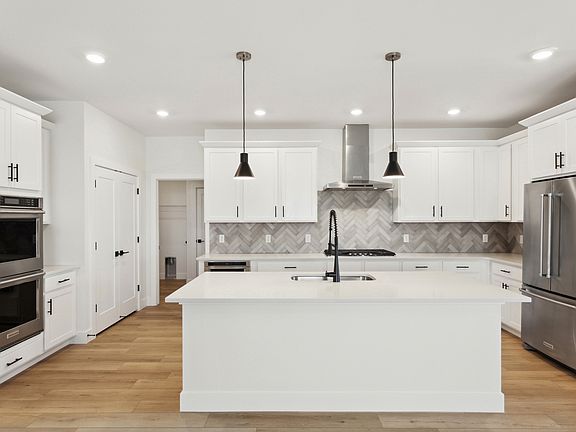 The kitchen has a wonderful island with quartz countertops.