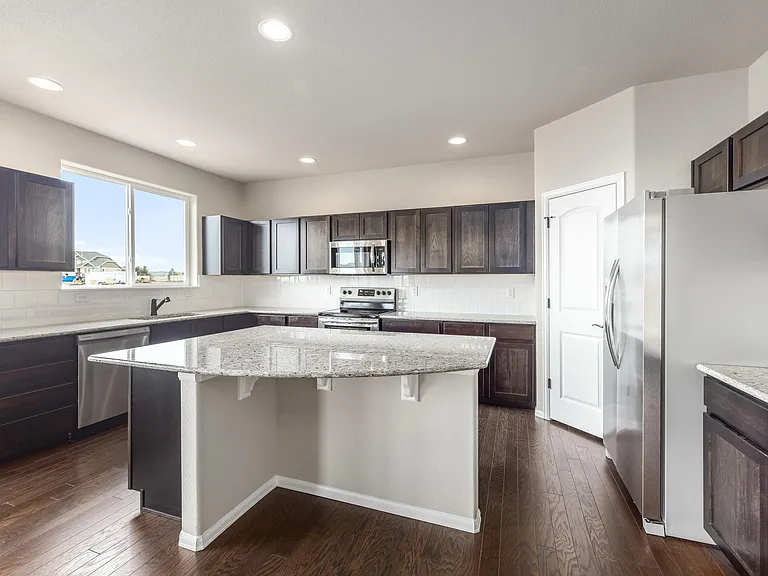 Beautiful Open Kitchen with Expresso Cabinets, Granite Countertops, Stainless Steel Appliances and LVP Flooring