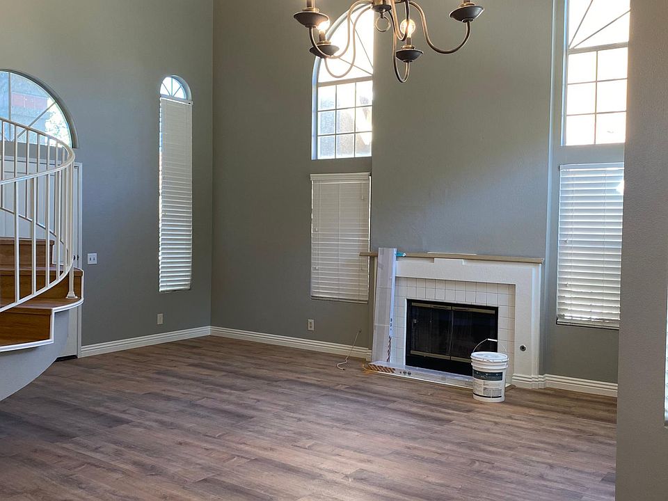 Entry way/Living room with new water proof vynal flooring including staircase cases. In addition each step of the stair has it's matching molding.