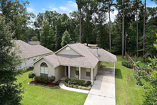 Long driveway with a covered carport.