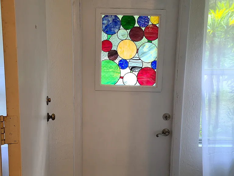 Front Door with stained glass window.