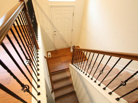 The entry is enhanced by the impressive iron spindled stairc