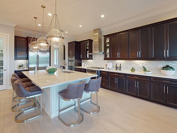 The large kitchen is a home chef s dream, with an oversized center island, extensive cabinetry, all-