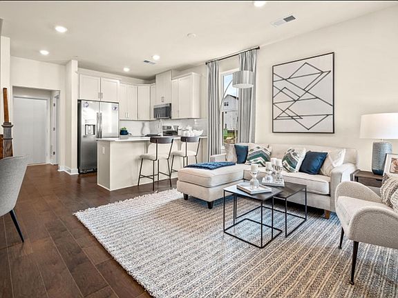 Kitchen The modern kitchen features wraparound granite countertops for food prep and bar-style seating, as well as a complete set of new stainless steel appliances to create delicious meals of all sizes.