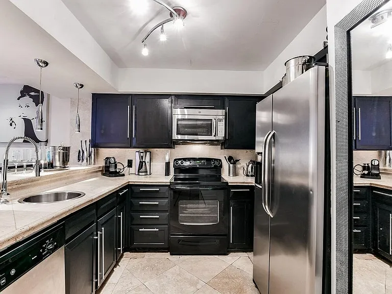 Spacious Modern Kitchen with a dine-in bar and stainless steel appliances