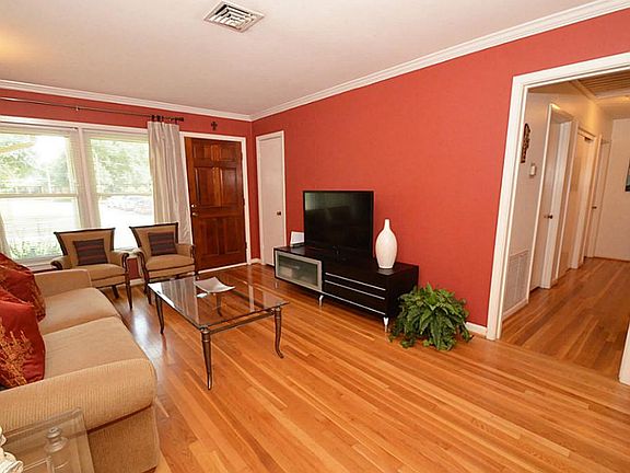Impressive entry into front living area! New double pane windows in the living allows natural light to show off the gorgeous original solid wood floors!