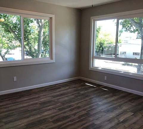 Large picture windows in the living room. All new dual pane windows, wood laminate flooring, decorator two tone paint, LED ceiling fan with dimmer switch, recessed lighting, and closet storage.