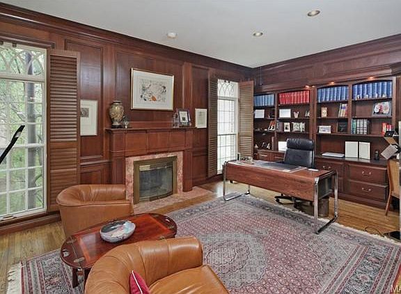 Magnificent cherry wood paneled library/living room with custom