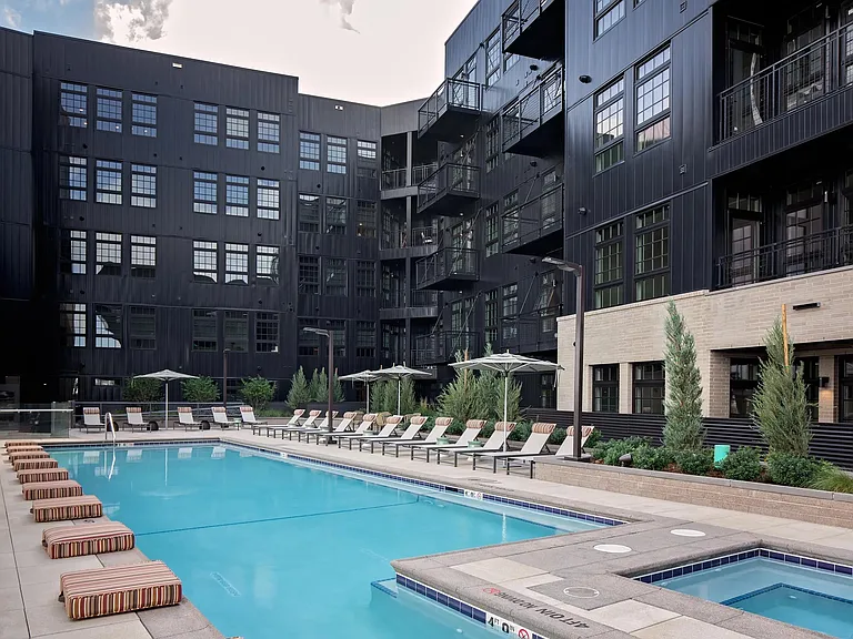 Pool and spa deck designed for relaxation, featuring a bar area and fire pit seating