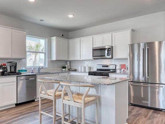 Spacious Kitchen with classic white cabinets.