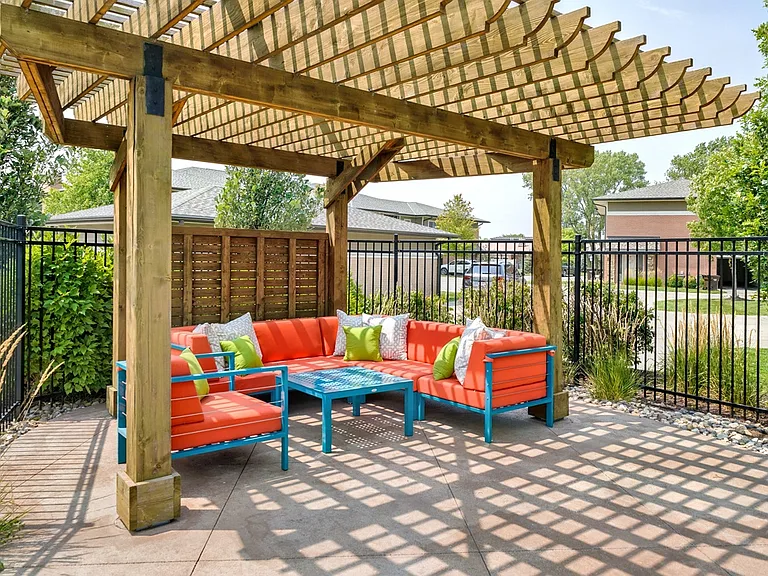 Relax under the pergola in a cozy outdoor lounge next to our pool.