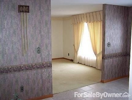 Formal living room : Carpeted living room with bay window, view from foyer