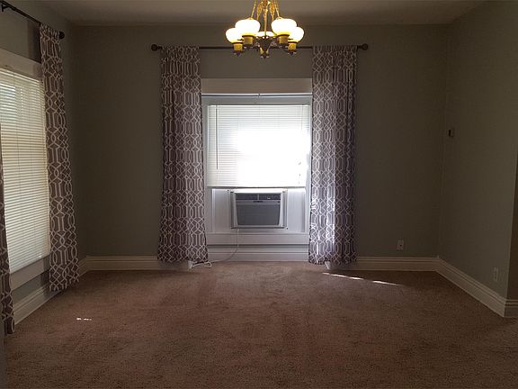 Standing in the doorway of a bedroom, this is the living room with the dining room off to the right.