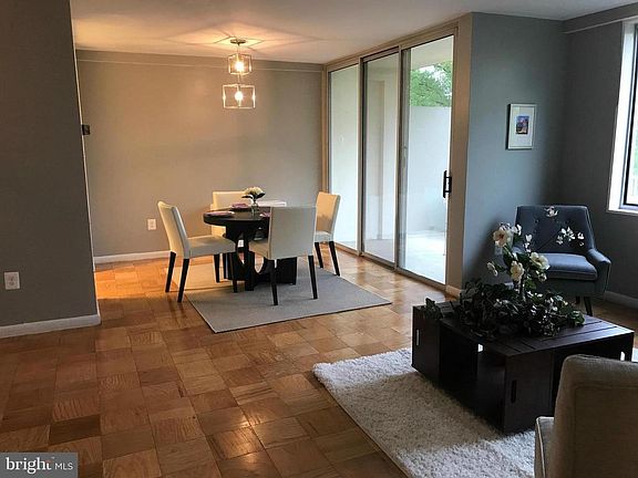 Living room, dining room combo with access to spacious balcony that backs to woods
