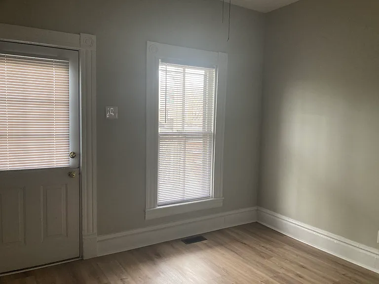 Plenty of room for your kitchen table. The door on the left leads to your private back porch.