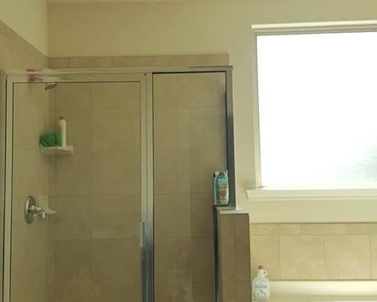 Master bath with tray ceiling, standing shower and garden tu