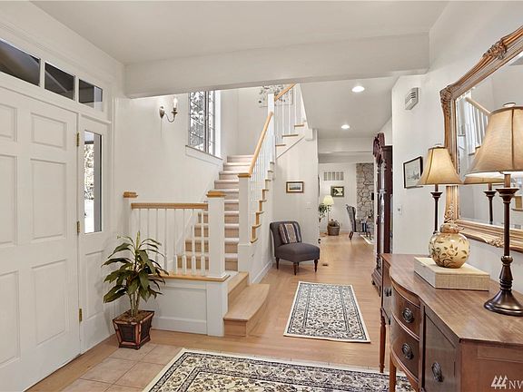 This high-bank waterfront home sits handsomely amid the evergreen trees on an extra large, 1.5 lot parcel.