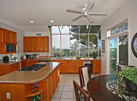 Granite Countertops in this Large Kitchen with an Island, Pantry, Breakfast Nook, Ceiling Fan, Newer Sliding Door to the Yard, a