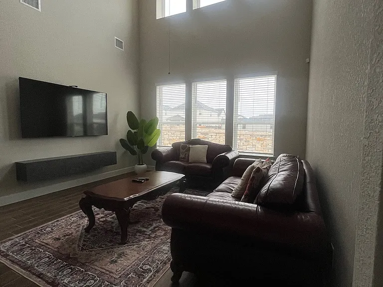 Bright, spacious living room with soaring ceilings and abundant natural light_perfect for relaxing or entertaining with plenty of room to gather.