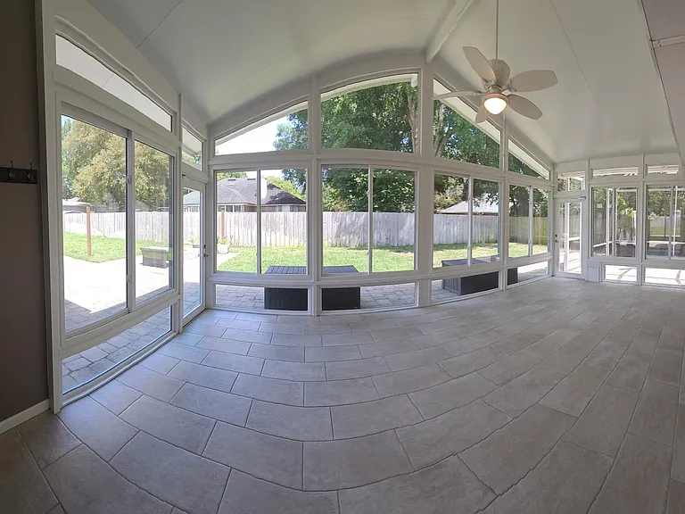 Panorama shot of the sunroom. Previously used as a gym and sitting room. Easily housed a treadmill, weight sets, and sunroom furniture (Couch and club seats.)