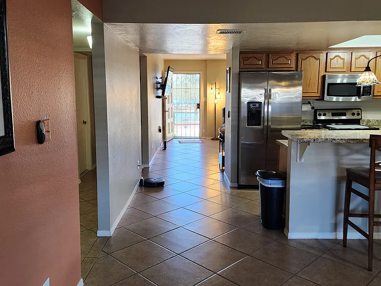 Dining room & kitchen flow through living room front on Chaparral lake.