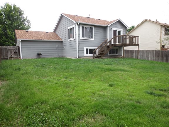Big fenced in back yard with shed