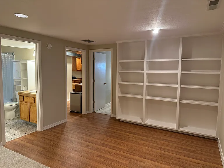 Nice bookcase storage next to dining area