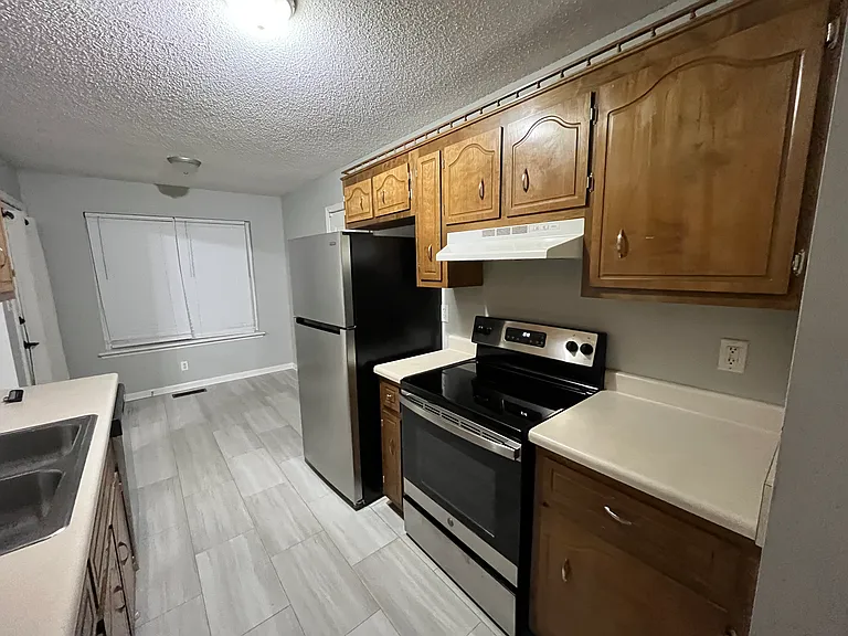Kitchen with dishwasher, oven, refrigerator, freezer, oven, and microwave.