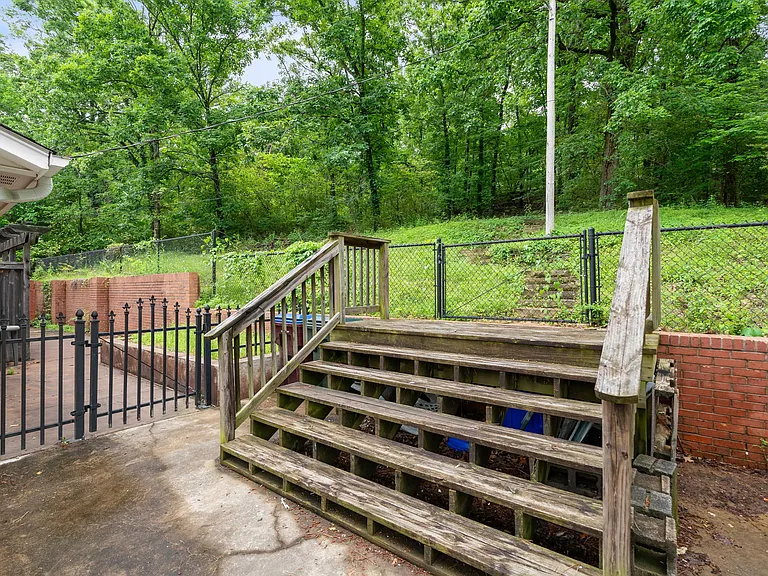 Close up of stirs leading to the wooded acreage on the property